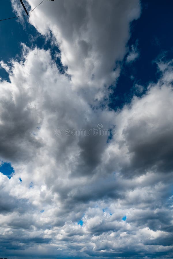 The dark sky with heavy clouds converging and a violent storm before the rain. Bad or moody weather sky and environment stock images
