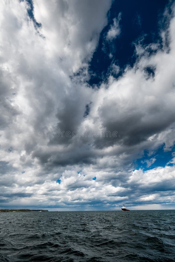 The dark sky with heavy clouds converging and a violent storm before the rain. Bad or moody weather sky and environment royalty free stock photography