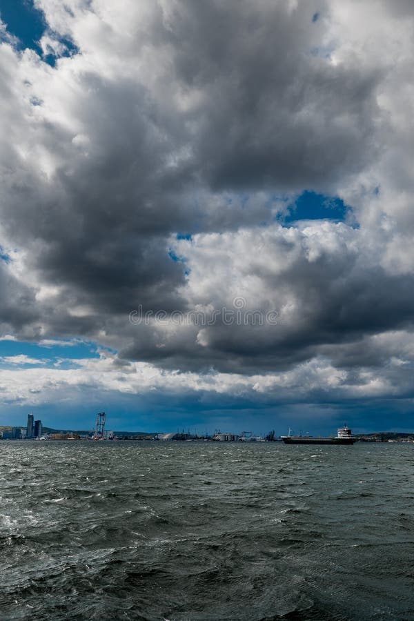 The dark sky with heavy clouds converging and a violent storm before the rain. Bad or moody weather sky and environment royalty free stock photo