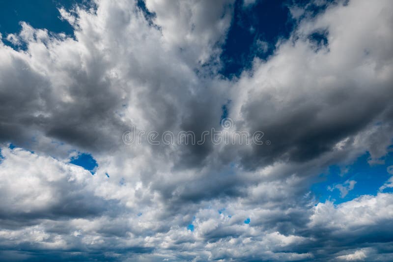The dark sky with heavy clouds converging and a violent storm before the rain. Bad or moody weather sky and environment stock images