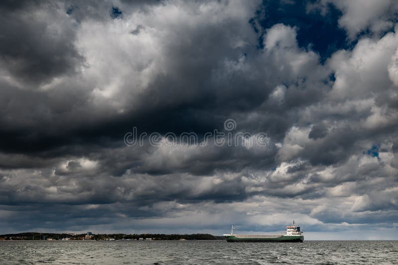The dark sky with heavy clouds converging and a violent storm before the rain. Bad or moody weather sky and environment stock photos