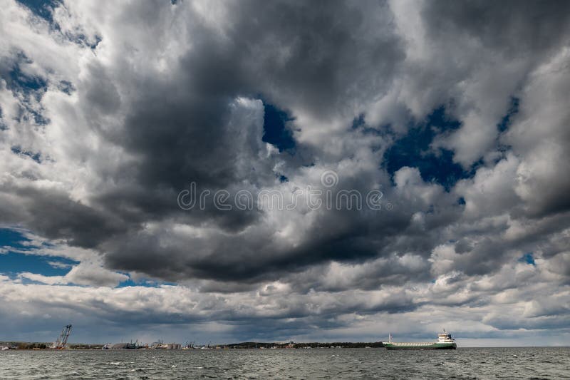 The dark sky with heavy clouds converging and a violent storm before the rain. Bad or moody weather sky and environment royalty free stock photos