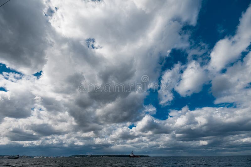 The dark sky with heavy clouds converging and a violent storm before the rain. Bad or moody weather sky and environment stock image