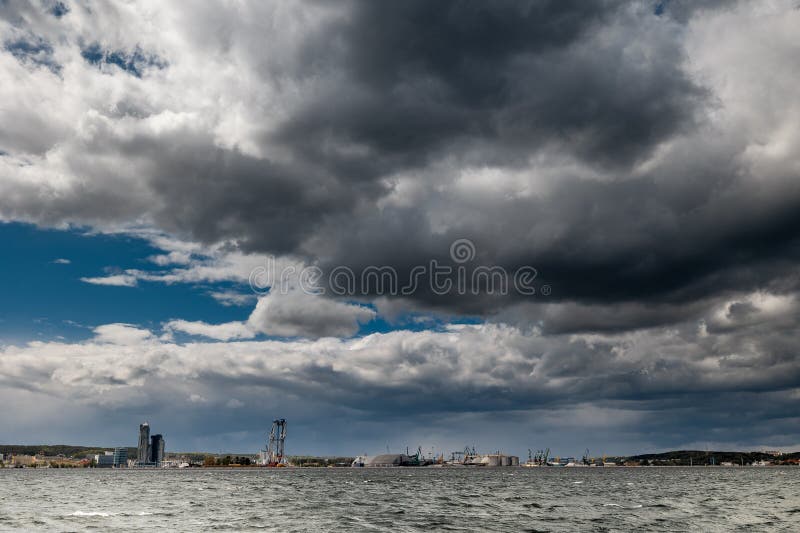 The dark sky with heavy clouds converging and a violent storm before the rain. Bad or moody weather sky and environment stock photography