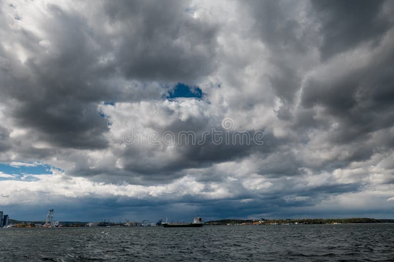 The dark sky with heavy clouds converging and a violent storm before the rain. Bad or moody weather sky and environment stock image