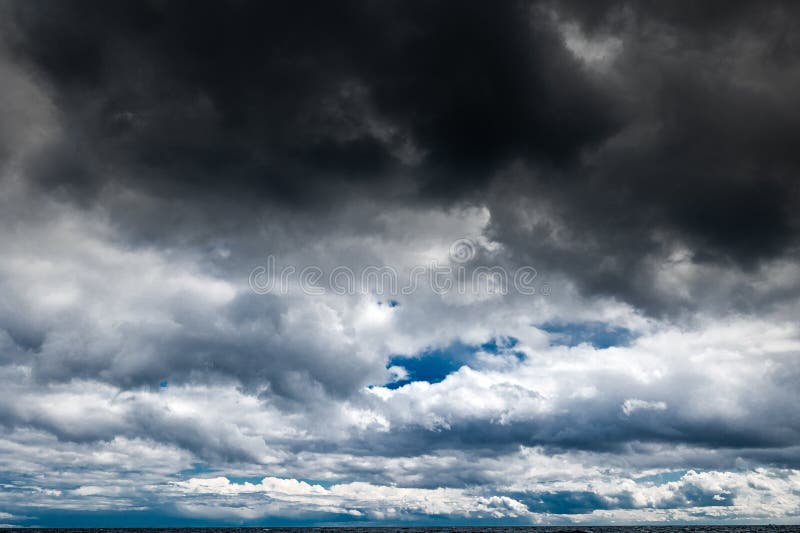 The dark sky with heavy clouds converging and a violent storm before the rain. Bad or moody weather sky and environment royalty free stock images