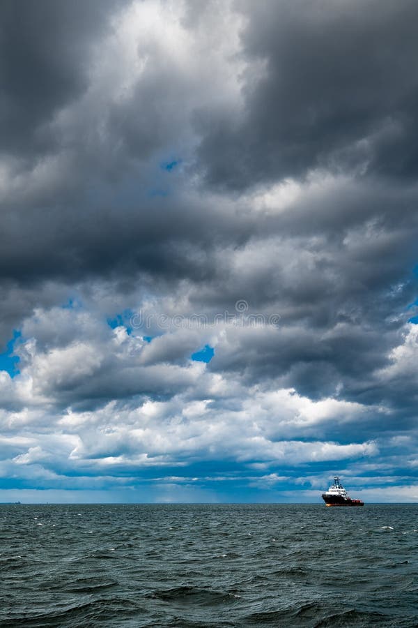 The dark sky with heavy clouds converging and a violent storm before the rain. Bad or moody weather sky and environment royalty free stock photography