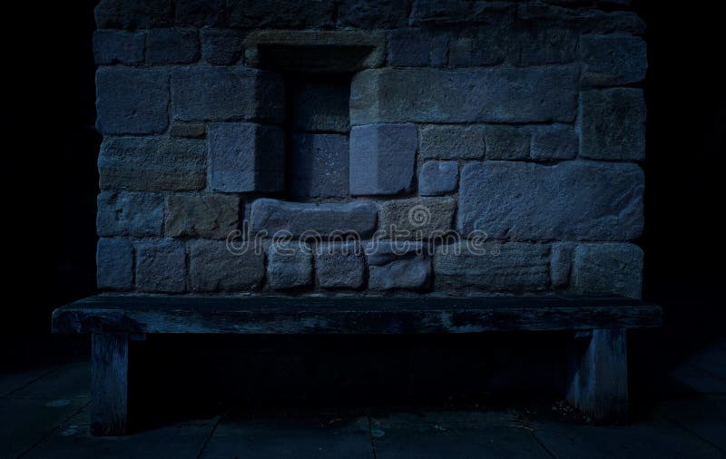 A dark spooky background of a wood bench