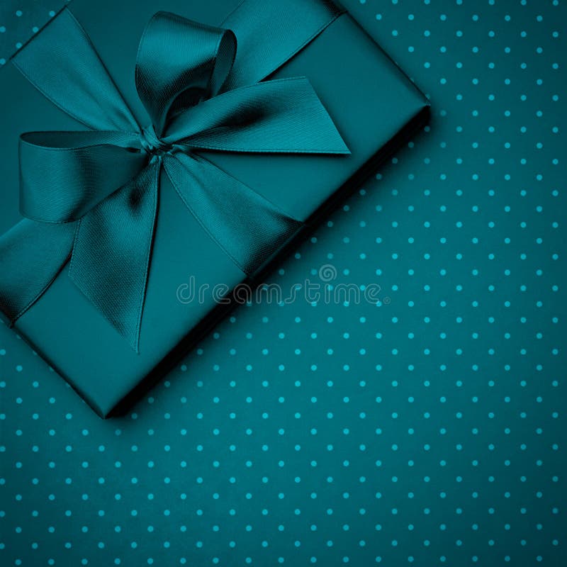 Dark turquoise gift box flat lay on dark turquoise background. Concept present box decoration holiday top view. Copy Space royalty free stock photos