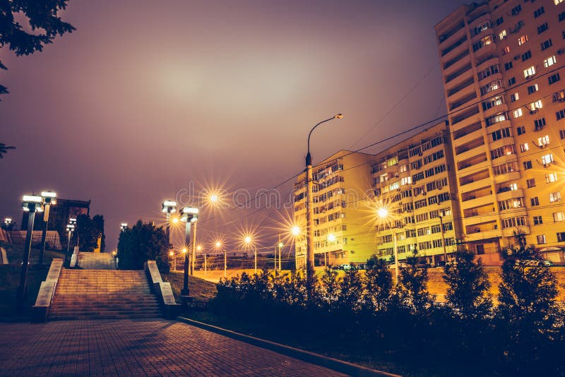 Dark urban alley at night with street lamps and houses royalty free stock image Dark urban alley at night with street lamps and houses royalty free stock image