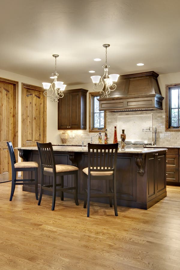 Dark Wood Kitchen with Granite Counters Stock Image - Image of cream