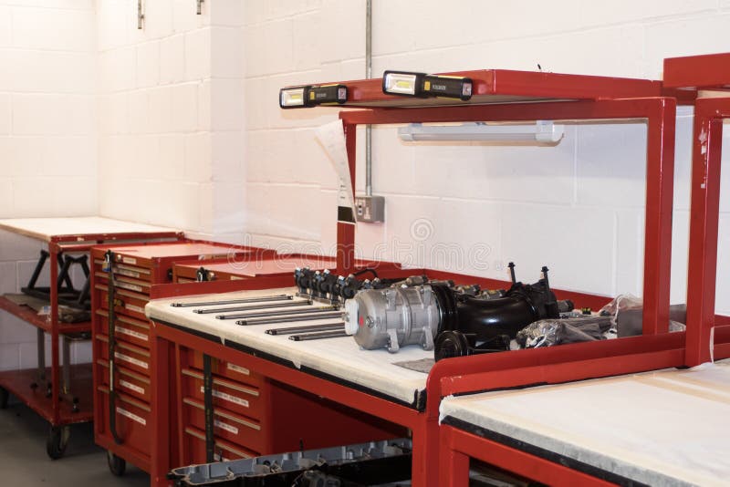 Workstation area inside a factory with machine parts on workbench