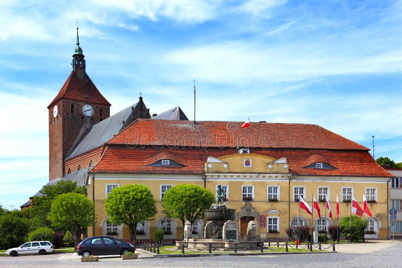 Darlowo, Poland - Historic quarter and market square with medieval St. Mary\ s Church, city hall and Fountain - Fisherman Memorial