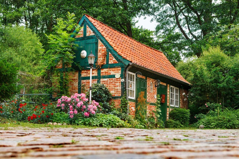Darmstadt, Germany-June 22, 2011:Small, fairy house with a tiled roof. The house is a workshop for making ceramic products royalty free stock photo Darmstadt, Germany-June 22, 2011:Small, fairy house with a tiled roof. The house is a workshop for making ceramic products royalty free stock photo