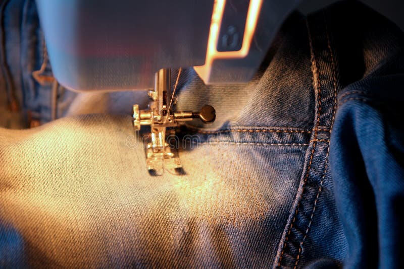 Darn jeans on the machine stock image. Image of tailor 49257145