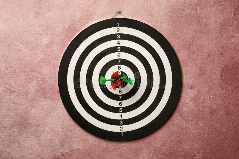 Dart board with arrows hitting target