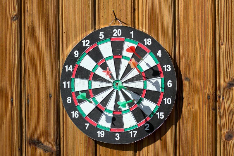 Dartboard on wood wall stock image. Image of green, leisure 26530263