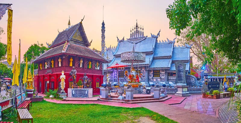 Panorama of the small garden and beautiful shrines of Silver Temple with wooden Ho Trai manuscript depository and the Ubosot behind Ganesha altar, Chiang Mai, Thailand. Panorama of the small garden and beautiful shrines of Silver Temple with wooden Ho Trai manuscript depository and the Ubosot behind Ganesha altar, Chiang Mai, Thailand