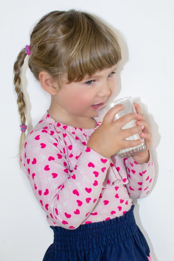 Das kleine Mädchen trinkt Milch, den Nutzen von Milch und Kalzium für Kinder Ein Kind von drei Jahren stockfoto Das kleine Mädchen trinkt Milch, den Nutzen von Milch und Kalzium für Kinder Ein Kind von drei Jahren stockfoto