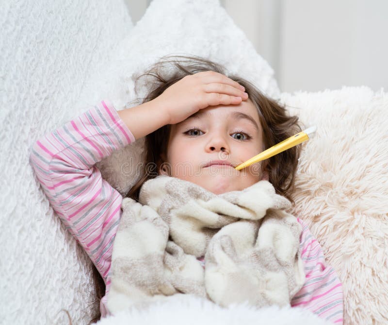 Sick girl lying in bed with a thermometer in mouth and touch his forehead. Sick girl lying in bed with a thermometer in mouth and touch his forehead.