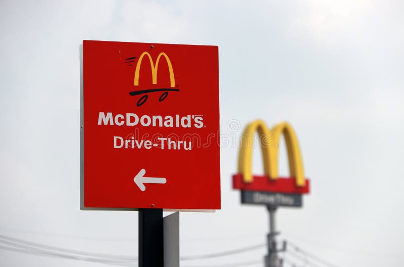 PakKret, Nonthaburi, Thailand - March 1, 2018: The red sign of McDonald drive thru at daylight and out focus dicut style of McDonald`s logo. The McDonald`s Corporation is the world`s famous restaurant. PakKret, Nonthaburi, Thailand - March 1, 2018: The red sign of McDonald drive thru at daylight and out focus dicut style of McDonald`s logo. The McDonald`s Corporation is the world`s famous restaurant