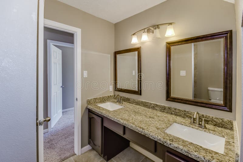 Nicely crafted granite top bathroom with double his and her sinks. Nicely crafted granite top bathroom with double his and her sinks.