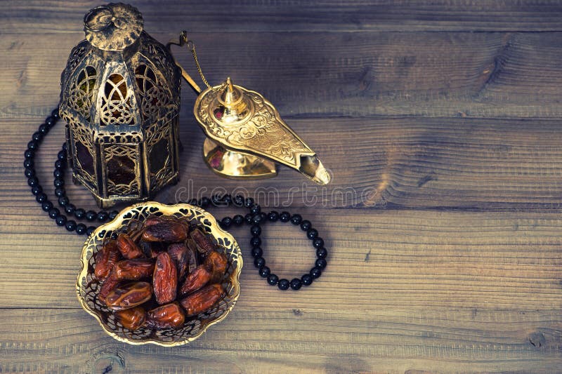Dates, arabian lantern and rosary. Islamic holidays concept. Ramadan decoration. Retro style toned picture. Dates, arabian lantern and rosary. Islamic holidays concept. Ramadan decoration. Retro style toned picture