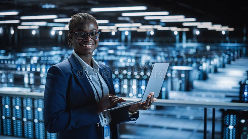 Data Center: Female Programmer Using Laptop Computer, Smiling and ...