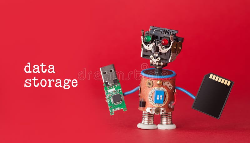Data storage concept. Robot toy with usb flash stick and memory card on red background. Copy space macro view royalty free stock photo Data storage concept. Robot toy with usb flash stick and memory card on red background. Copy space macro view royalty free stock photo