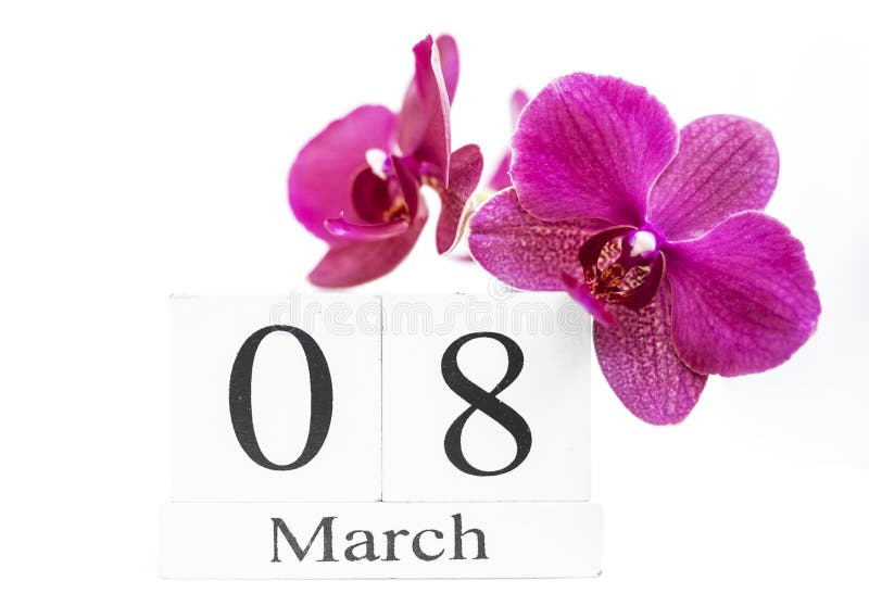 Date white block calendar for International Women`s Day, March 8, decorated with orchid flower