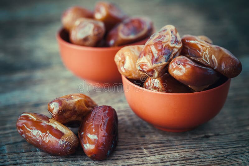 Dates fruits in bowl. Retro tonedo.