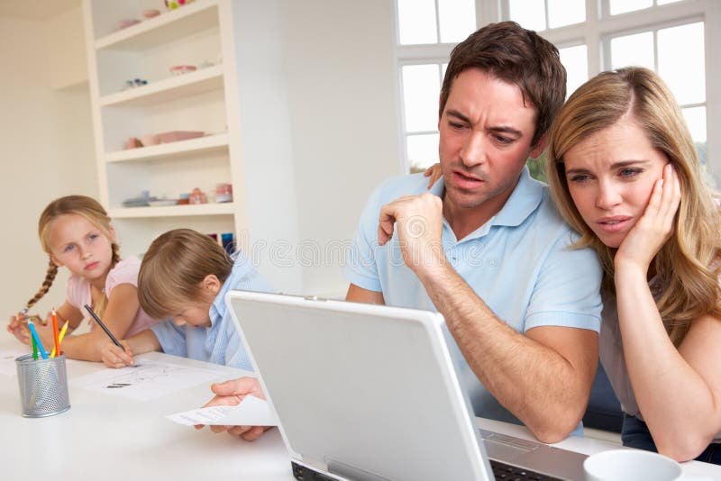 Young couple thinking and looking at a laptop computer. Young couple thinking and looking at a laptop computer