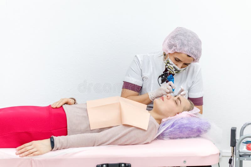 Dauerhaftes Make-up, Tätowieren von Augenbrauen Das Cosmetologistzutreffen bilden lizenzfreies stockbild Dauerhaftes Make-up, Tätowieren von Augenbrauen Das Cosmetologistzutreffen bilden lizenzfreies stockbild