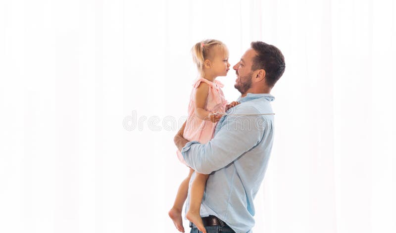 Daughter kissing her father sitting on his hands royalty free stock images Daughter kissing her father sitting on his hands royalty free stock images