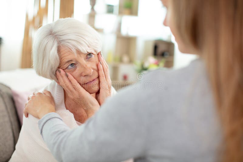 Daughter supports elderly mother in difficult moment stock photography