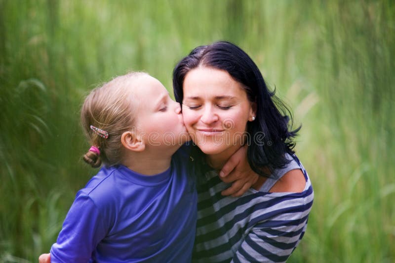 The daugther kisses her mother