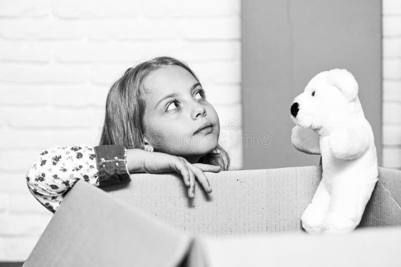 Day dreamer. happy little girl with toy. purchase of new habitation. repair of room. new apartment. happy child stock photo Day dreamer. happy little girl with toy. purchase of new habitation. repair of room. new apartment. happy child stock photo