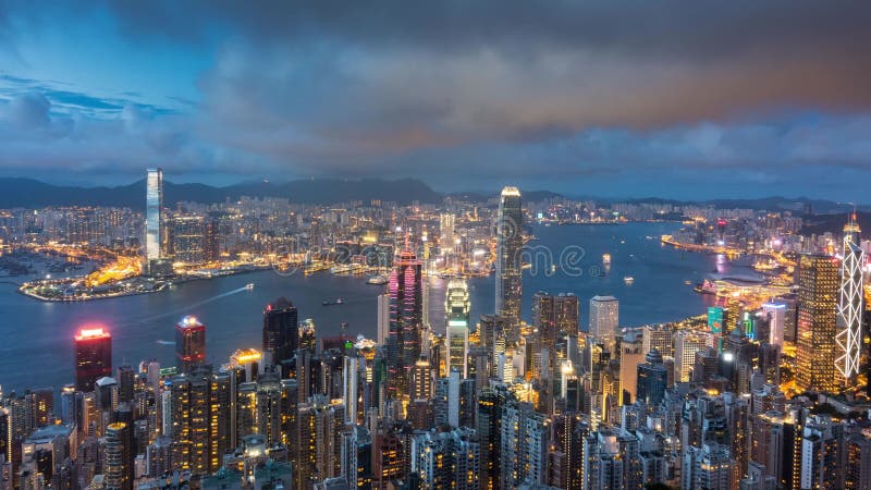 Day to night time lapse of Hong Kong cityscape aerial view from victoria peak on high mountain, famous landmark for travel in Hong