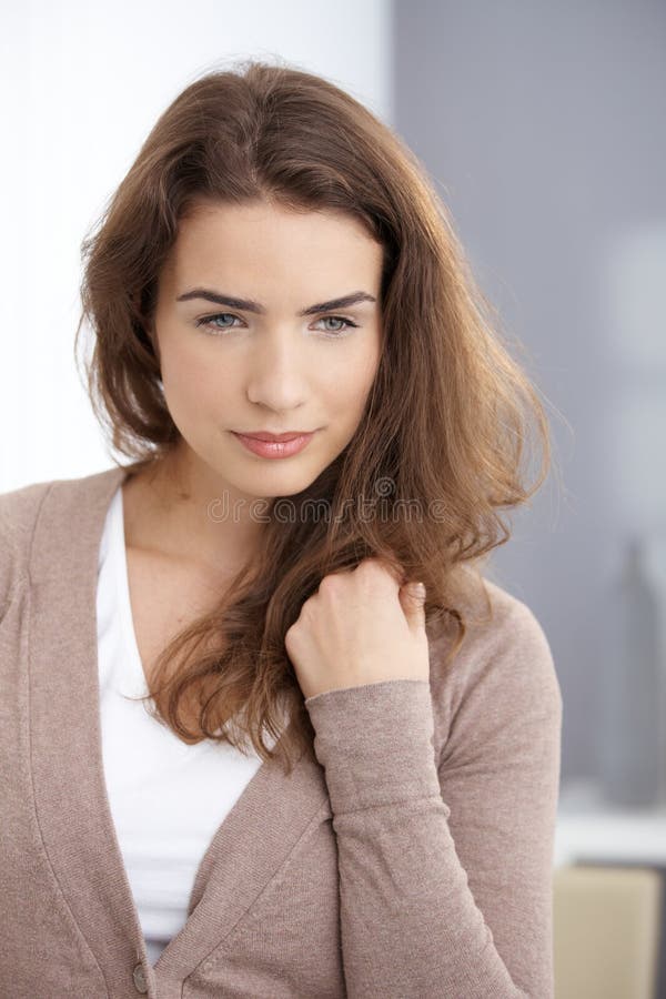 Daydreaming woman standing at wall