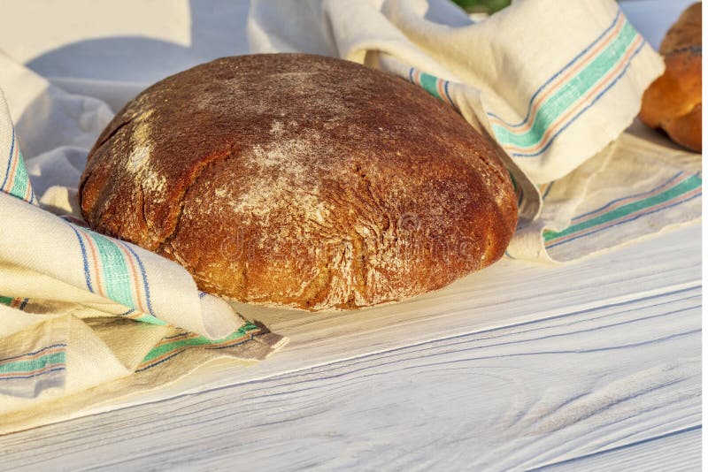 Daylight. rye bread on a white wooden background. Copy space stock photo