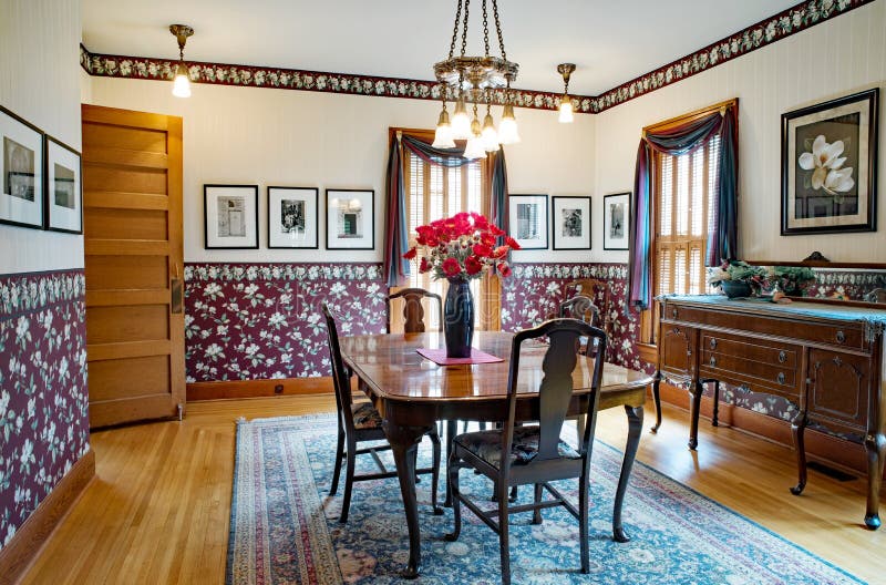 Victorian Dining Room Interior. Dayton, Ohio, USA - June 10, 2018: Example of Victorian dining room with flowered wallpaper in burgundy & cream satin stripe royalty free stock photo Victorian Dining Room Interior. Dayton, Ohio, USA - June 10, 2018: Example of Victorian dining room with flowered wallpaper in burgundy & cream satin stripe royalty free stock photo