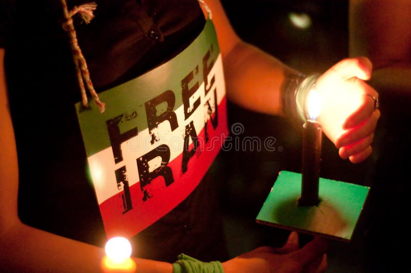 WASHINGTON, DC - JULY 2, 2009: Activists participate in a candle light vigil at Washington, DC's Dupont Circle park to protest the outcome of Iranian elections in which Mahmoud Ahmadinejad claimed victory, and after which scores of Iranians have been killed in protests. WASHINGTON, DC - JULY 2, 2009: Activists participate in a candle light vigil at Washington, DC's Dupont Circle park to protest the outcome of Iranian elections in which Mahmoud Ahmadinejad claimed victory, and after which scores of Iranians have been killed in protests.