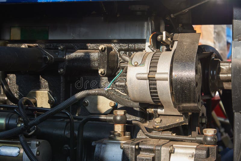 DC Generator in the Engine Compartment of the Mini Tractor Stock Photo