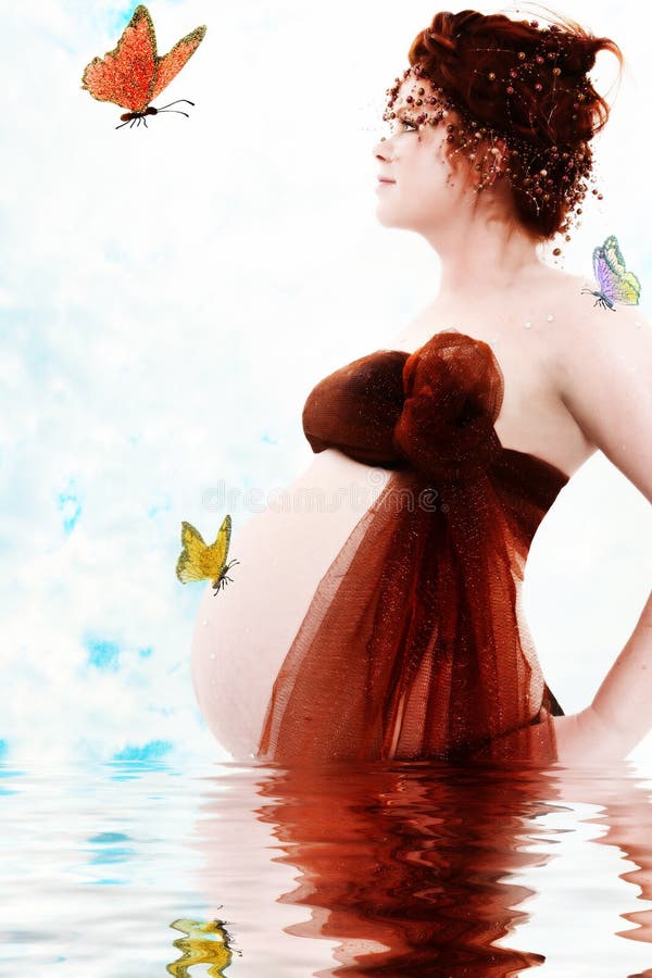 Fantasy maternity portrait of water princess and butterflies. Nine months pregnant over white sky background with water reflection. Fantasy maternity portrait of water princess and butterflies. Nine months pregnant over white sky background with water reflection.