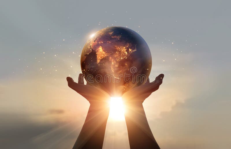 Earth at night was holding in human hands on the sunset sky. Earth day. Energy saving concept, Elements of this image furnished by NASA. Earth at night was holding in human hands on the sunset sky. Earth day. Energy saving concept, Elements of this image furnished by NASA
