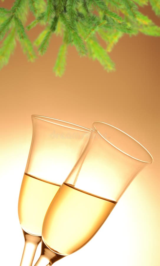 Pair of champagne flutes and Christmas decoration on orange background. Pair of champagne flutes and Christmas decoration on orange background