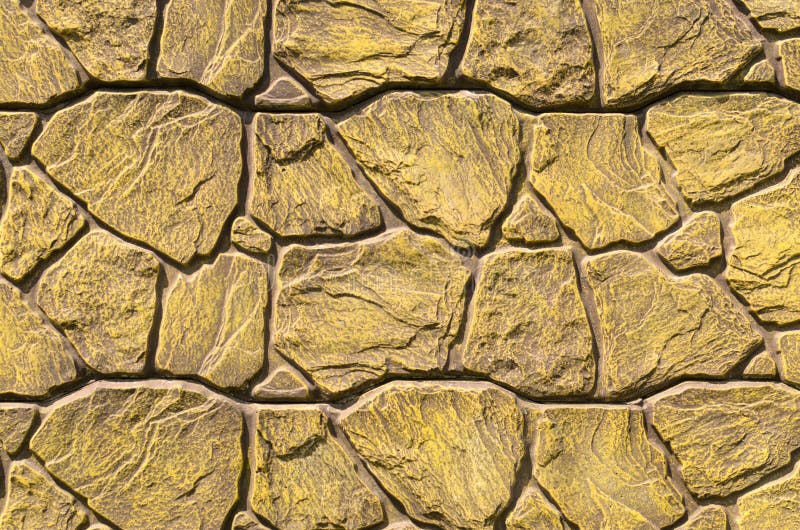 De achtergrond van oud goud platted bakstenen muur stock fotografie De achtergrond van oud goud platted bakstenen muur stock fotografie