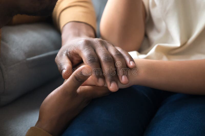 African american father dad holding hands of child as charity and support concept, children protection, kid adoption donation, black family love care connection, parenthood, upbringing, close up view. African american father dad holding hands of child as charity and support concept, children protection, kid adoption donation, black family love care connection, parenthood, upbringing, close up view