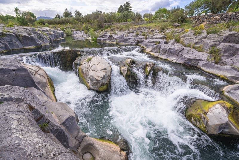 Waterfalls of Alcantara river near Castiglione di Sicilia village, Sicily in Italy, cascade, cascades, valley, park, island, italian, republic, isle, nature, landscape, scenic, scenics, scenery, natural, rock, rocks, protected, area, reserve, bioreserve, preserve, wilderness, bank, riverside, stone, stones. Waterfalls of Alcantara river near Castiglione di Sicilia village, Sicily in Italy, cascade, cascades, valley, park, island, italian, republic, isle, nature, landscape, scenic, scenics, scenery, natural, rock, rocks, protected, area, reserve, bioreserve, preserve, wilderness, bank, riverside, stone, stones