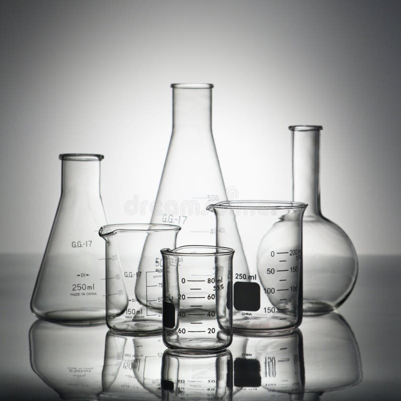 Glass science containers on grey background. Glass science containers on grey background.